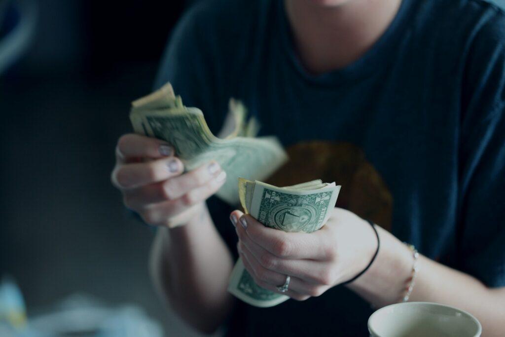 a personal counting dollar bills