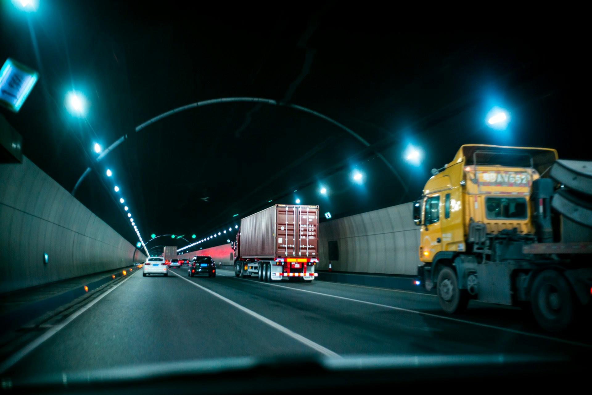 cars and trucks speeding through a tunnel
