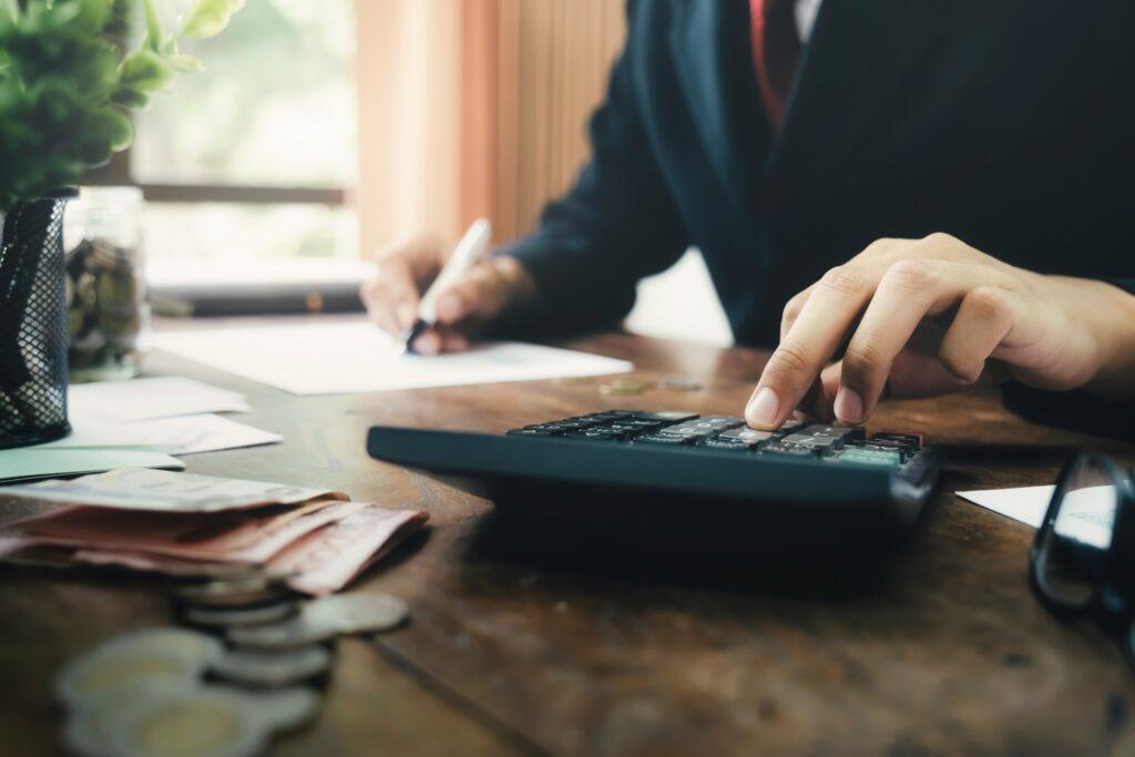 Lawyer calculating truck accident compensation costs at a desk, symbolizing financial recovery after an Aurora truck crash
