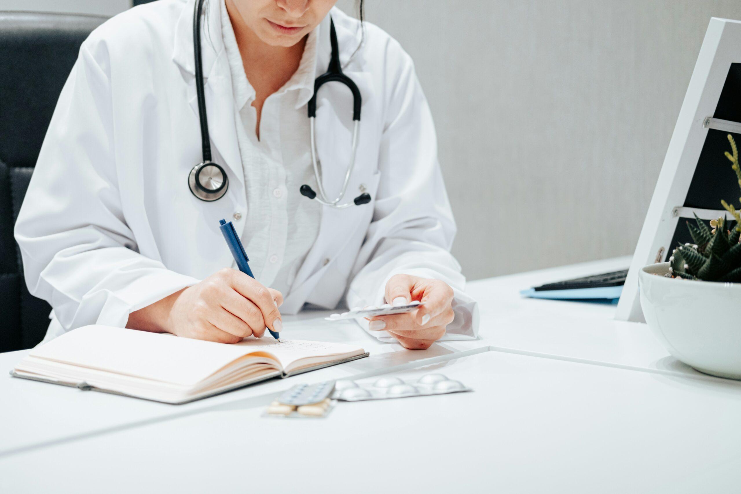 A person wearing a lab coat sitting at a desk