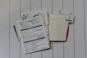 a pile of paperwork, including tax info for wage earners, sits on a table