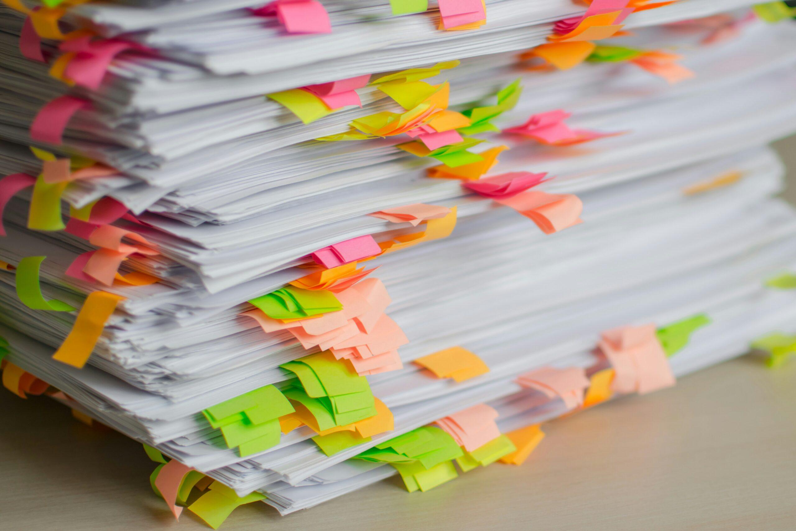 a stack of folders with brightly colored tabs sticking out of them.