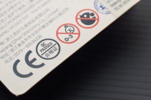 Close-up of a warning label on a consumer product package indicating potential hazards and safety precautions.