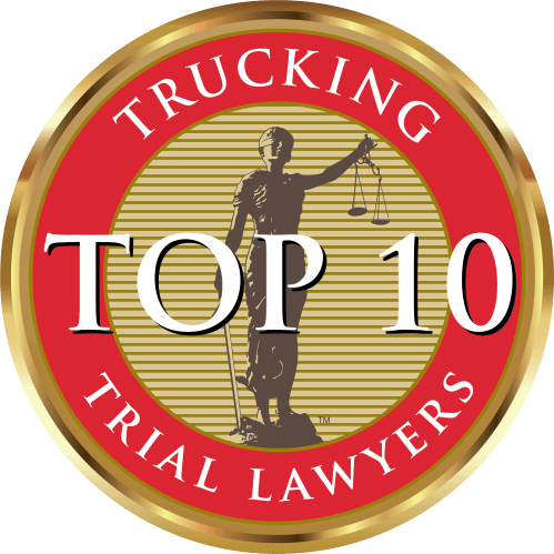Oval seal with a figure of Lady Justice holding scales, text: Trucking Top 10 Trial Lawyers